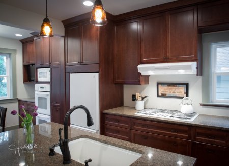 Cherry cabinets and Quartz countertops were great product choices to complement the white appliances.