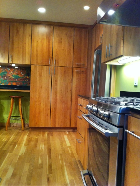View of pantry cabinets: Custom Alder Cabinetry.