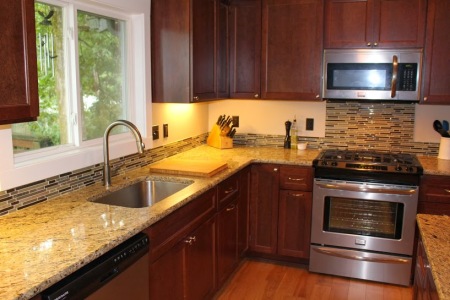After- view of sink, countertops and cabinets